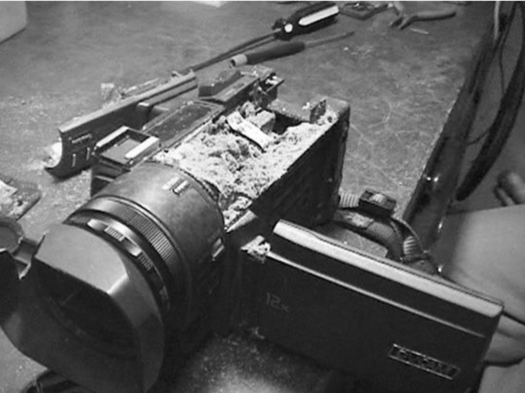A black and white image of a broken camera.